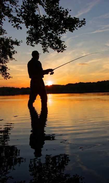 Someone flyfishing at sunset. Flyfishing is a local activity to participate in when you buy Carson City, NV real estate